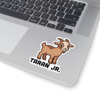 A cute brown cartoon baby goat sticker from thtgrlreads' Kindred's Curse Saga collection, placed on a silver laptop surface, featuring bold text beneath the goat graphic.