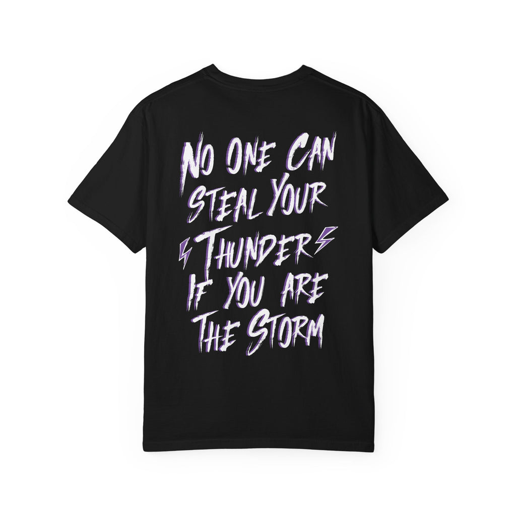 thtgrlreads black Comfort Colors graphic tee featuring a bold white and purple text design that reads "No one can steal your thunder if you are the storm" with lightning bolt accents.