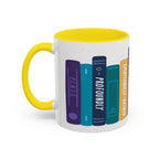 A white ceramic mug with a bright yellow handle and interior featuring a colorful graphic of books on a shelf, with titles like "Remus," "Profoundly," and "Emotionally Ruined" in a whimsical, hand-drawn style.