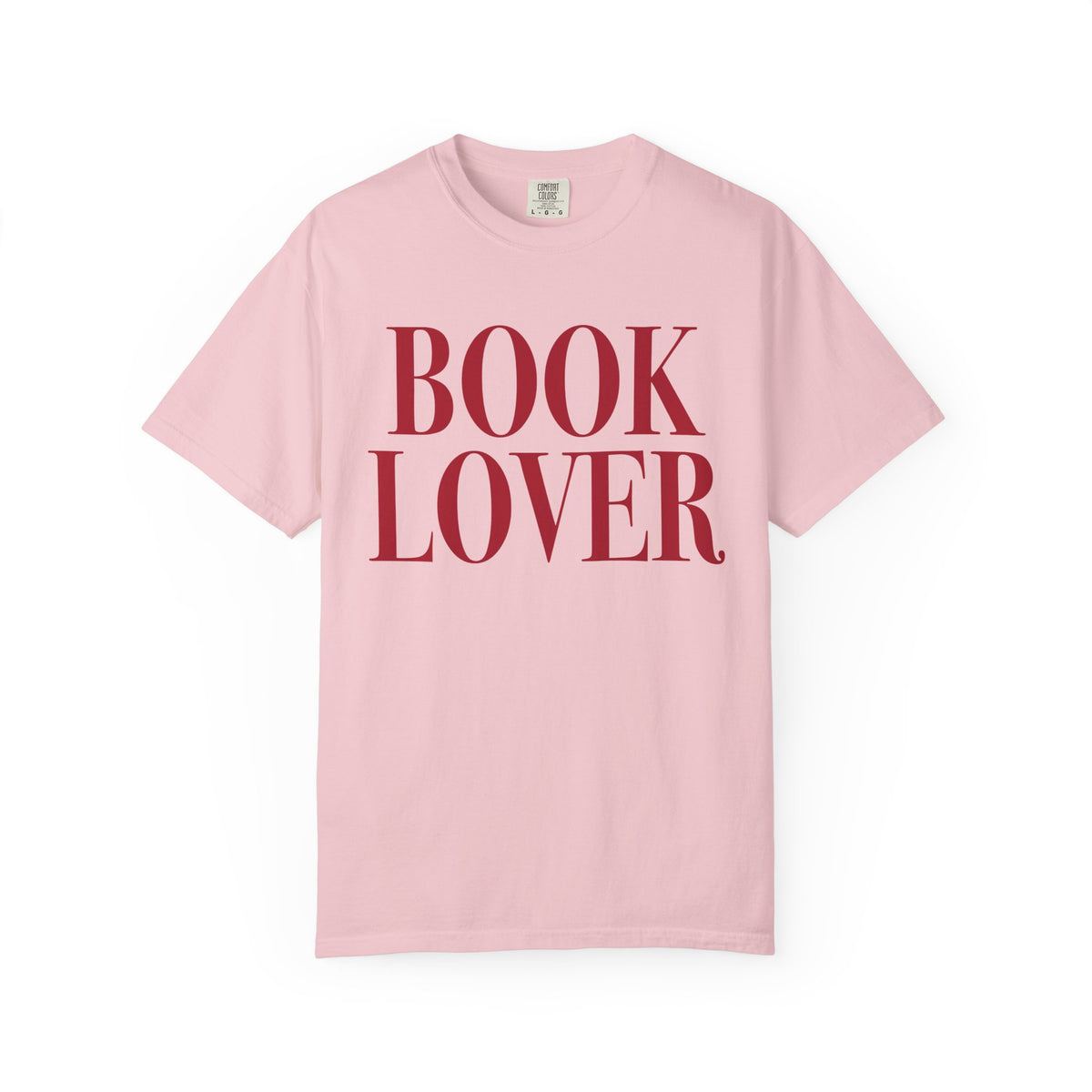 Comfort Colors vintage-washed pink graphic tee from thtgrlreads featuring bold red serif "BOOK LOVER" text, part of the Tees collection for bookish apparel fans.