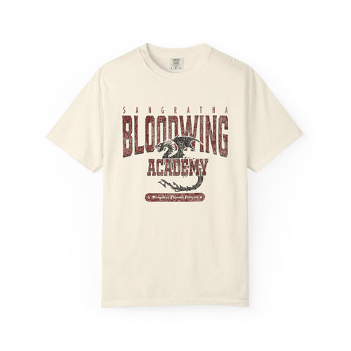 Cream Comfort Colors graphic tee from thtgrlreads featuring a vintage wash Bloodwing Academy design with a distressed dragon print, part of the Back to School and Tees collections.
