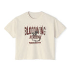 Bloodwing Academy crop top from thtgrlreads features a vintage wash Comfort Colors fabric with a distressed dragon graphic and bold Bloodwing Academy text, part of the Tees collection.