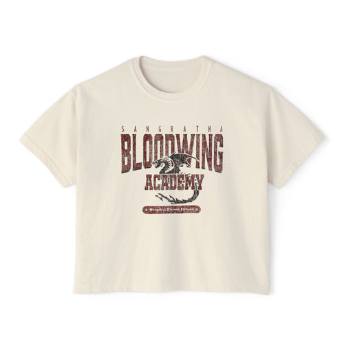 Bloodwing Academy crop top from thtgrlreads features a vintage wash Comfort Colors fabric with a distressed dragon graphic and bold Bloodwing Academy text, part of the Tees collection.