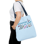 Light blue Readers in STEM tote bag with colorful science illustrations, carried over the shoulder. Ali Hazelwood licensed design by Printify.