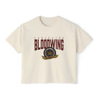 A cream-colored unisex Comfort Colors cropped t-shirt featuring a vintage wash and bold Bloodwing Academy graphic text with a circular emblem in maroon and gold, thtgrlreads.