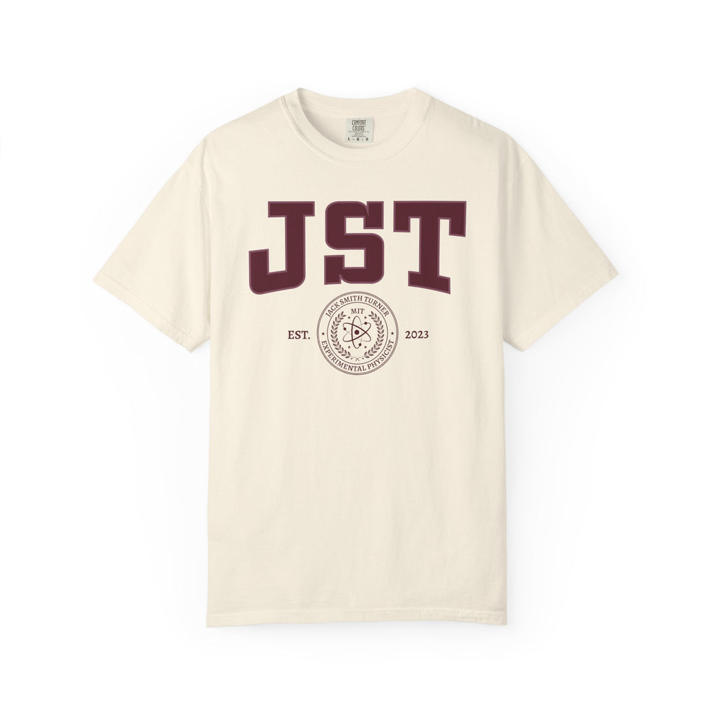 Cream Comfort Colors graphic tee featuring bold burgundy JST lettering and a circular MIT seal design, from the Ali Hazelwood Tees collection by Printify