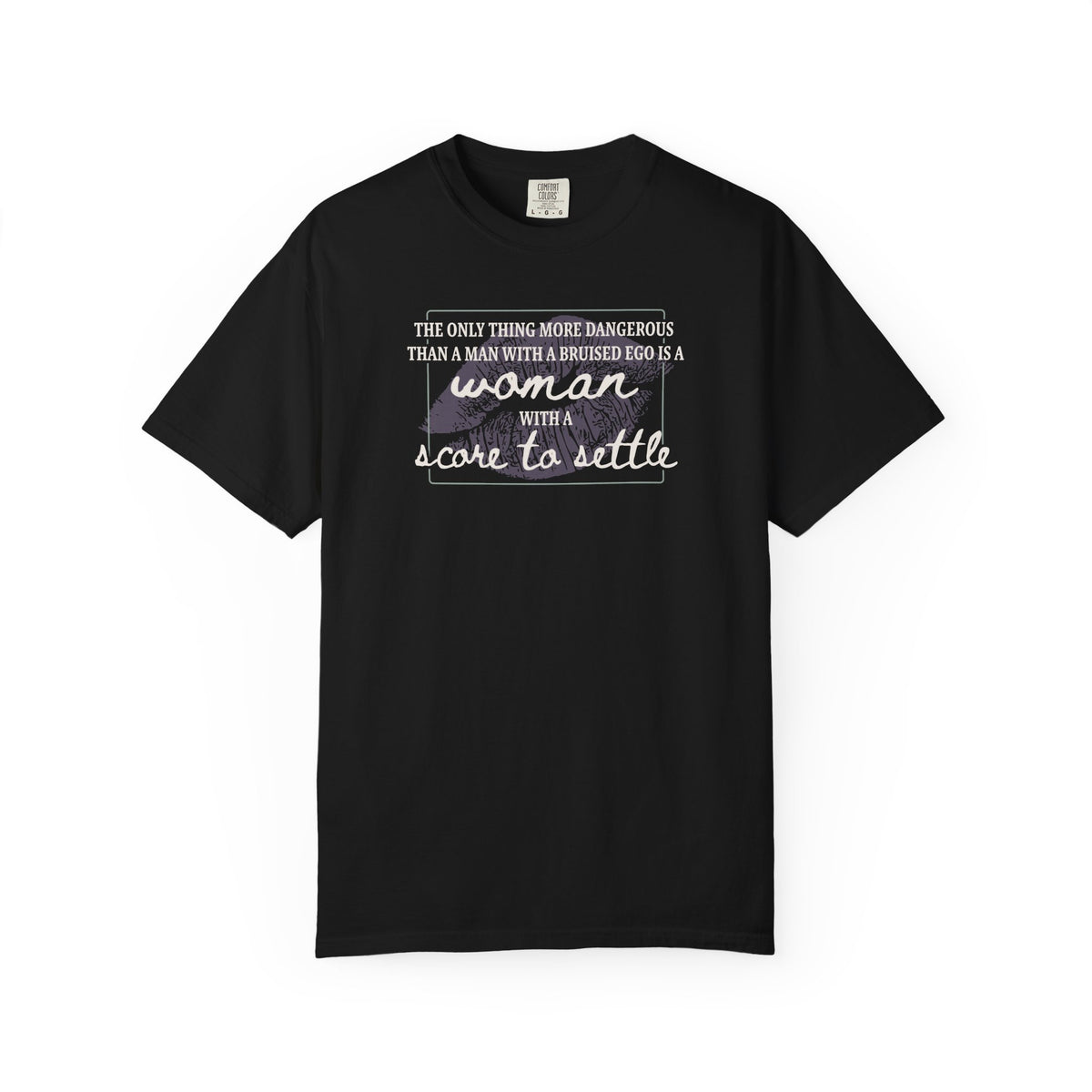 A black Comfort Colors graphic tee from thtgrlreads featuring a bold typographic design saying "The only thing more dangerous than a man with a bruised ego is a woman with a score to settle," part of The Poison Daughter and Tees collections.
