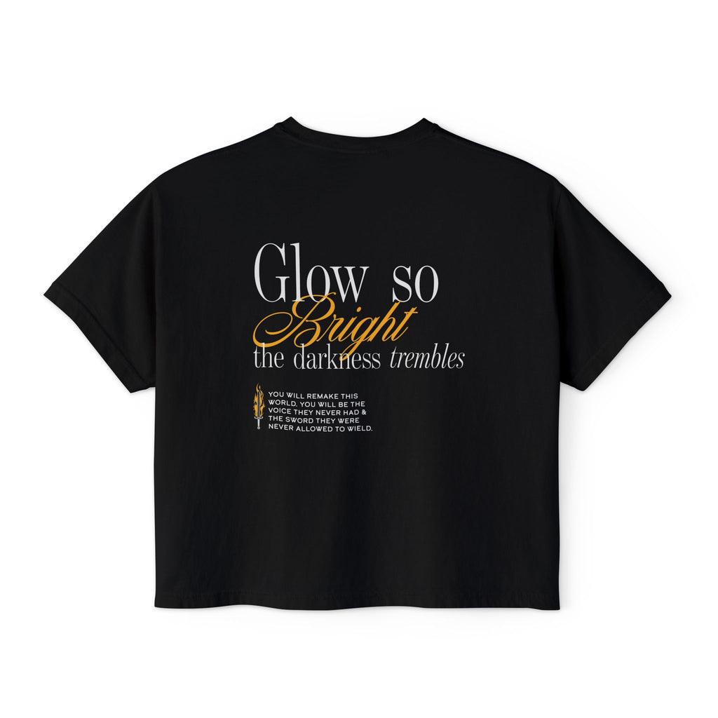 Kindred's Curse Saga crop top by thtgrlreads featuring a black Comfort Colors vintage wash crop t-shirt with a text design "Glow so Bright the darkness trembles" in white and gold script, part of officially licensed bookish apparel collections including gid://shopify/Collection/449367539962 and gid://shopify/Collection/467491553530.