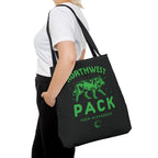Black Northwest Pack tote bag with a green wolf graphic and Koen Alexander text, carried over the shoulder as Ali Hazelwood licensed bookish merch by Printify