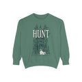 Thtgrlreads oversized crewneck from The Poison Daughter collection featuring vintage-wash green Comfort Colors fabric with a detailed graphic of a forest and a flowing-dress figure beneath "The Hunt" text in serif font.