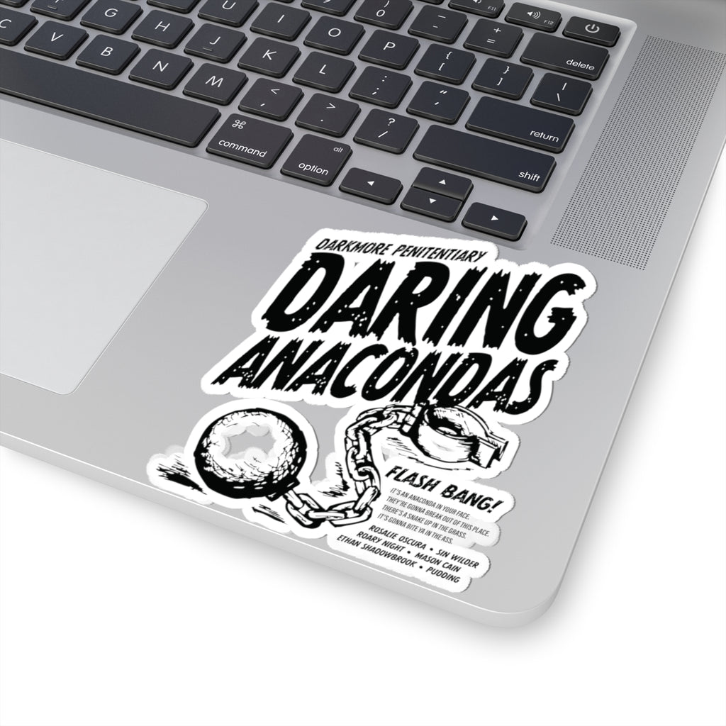 Black and white sticker on a laptop featuring bold, distressed text "Daring Anacondas" with "Darkmore Penitentiary" above, and an illustration of broken handcuffs with a chain.