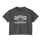 Liv Zander collection crop top from thtgrlreads featuring a vintage-wash Comfort Colors fabric with a bold white graphic reading "1st Annual Gravedigger Snowball Tournament" on a charcoal gray unisex cropped t-shirt.
